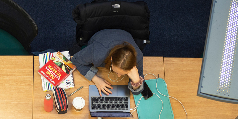 Student at work on a laptop in the Craiglockhart campus library.