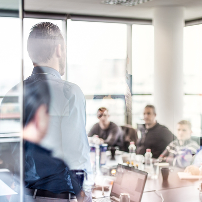 A business man giving a presentation in an office.