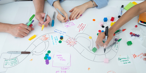 Hands drawing a diagram on paper
