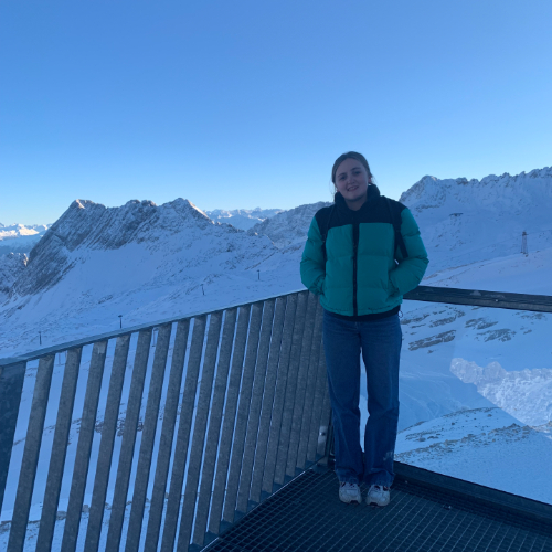 Tourism alumna, Ellen standing on a mountain