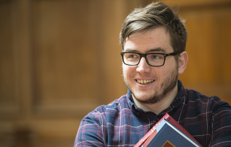 Law student Chris Enderby smiling at something to the left of the camera