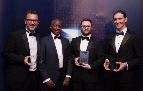 Four men standing smiling for the camera with trophies after winning Best New Cyber Talent’ at the Scottish cyber awards in 2017 