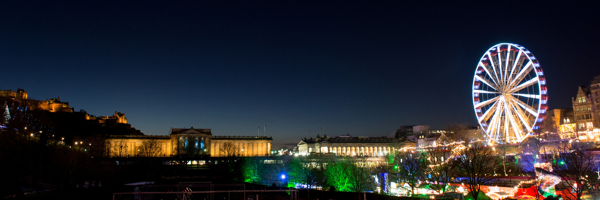 Edinburgh skyline at night during Christmas fair in Edinburgh's Princes Street Gardens.