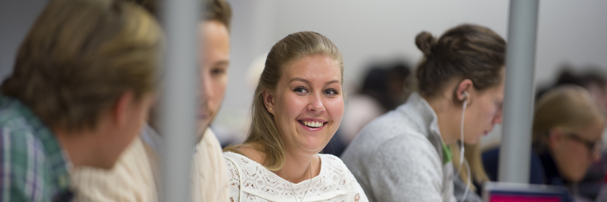 Edinburgh Napier students chatting and smiling as they work