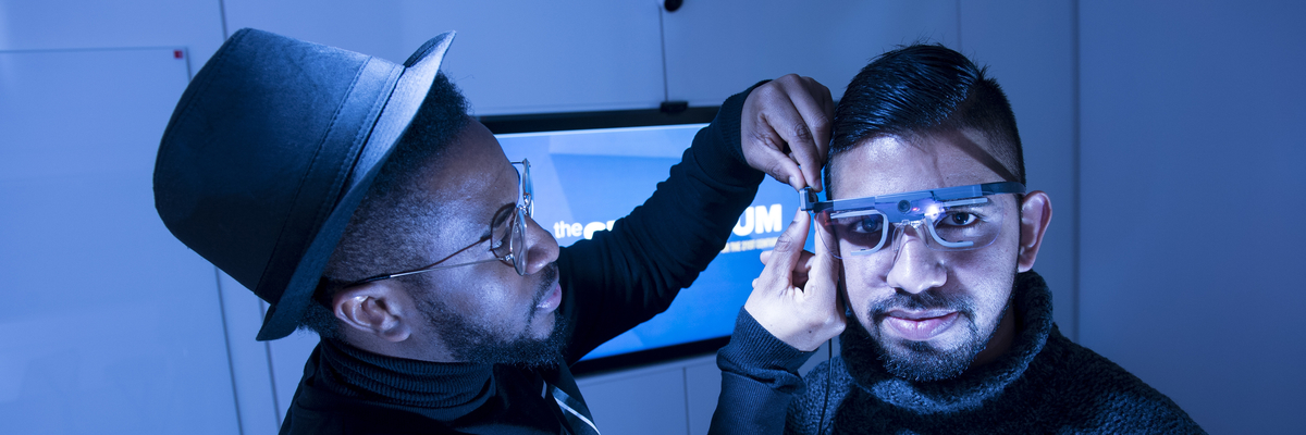 Students working with eye tracking glasses in the Sensorium user experience lab.