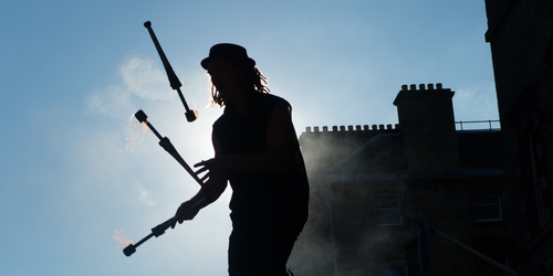Silhouette of a juggling Street performer at the Fringe festival