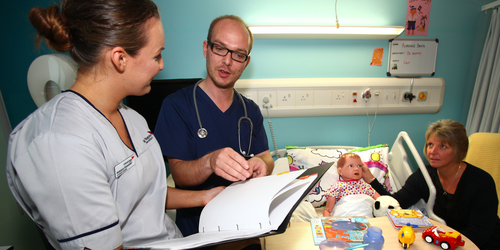 Medical staff visiting the bedside of a 'child' mannequin at the Clinical Skills and Simulation Centre at Napier University, Sighthill, Edinburgh