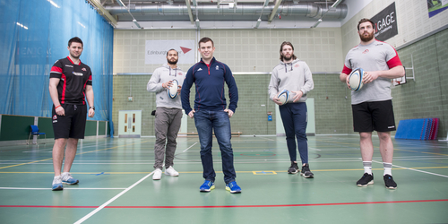 Students from the new Business and Enterprise in Sport BA course in a rugby and curling event all stand and smile for the camera