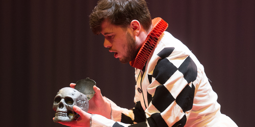 a man acting on stage, in a costume