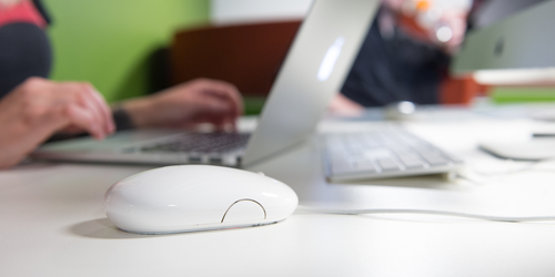 Close up of a computer mouse as a Student uses a laptop