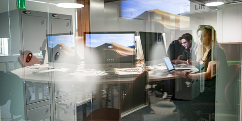 Students working in Apple computer studio