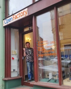 Alumnus Barnabas Cox standing in front of his business, OpenFactory