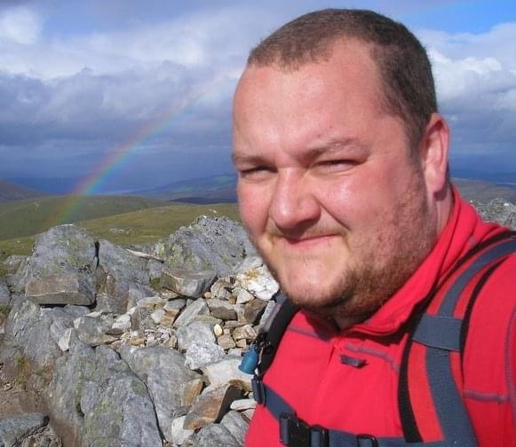 Taylor Hume standing on top of a hill