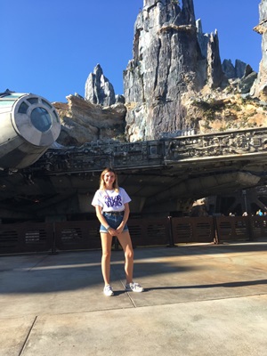 Iona standing in front of the Star Wars theme park ride 