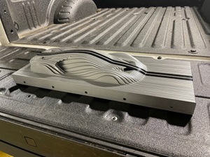 A grey model of a Ford GT car sitting on a grey table 