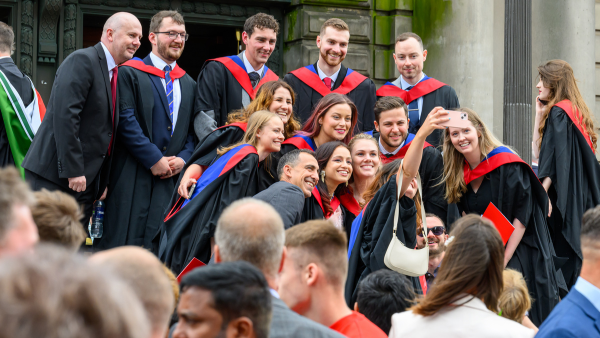 Graduates posing outside Usher Hall