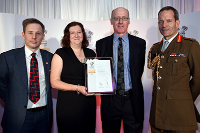 Gary Seath, Claire Biggar and Alistair Sambell, with Lieutenant General Tyrone Urch, receiving the Armed Forces Coventant Gold Award in London, in November 2019