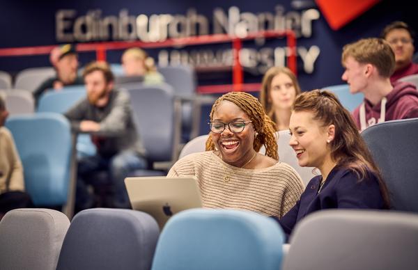 Students conversing with each other while they study in Edinburgh Napier University's new Riady lecture theatre. 