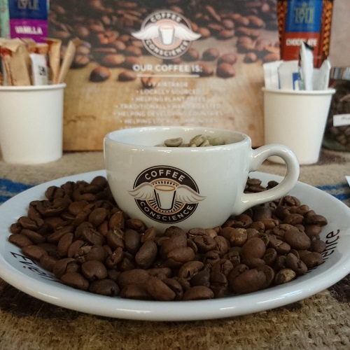 Coffee cup surrounded by coffee beans
