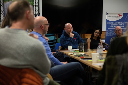 A group of people sitting around a meeting room table