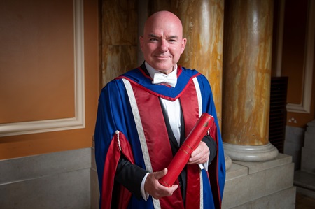 James Matthews poses with his honorary degree
