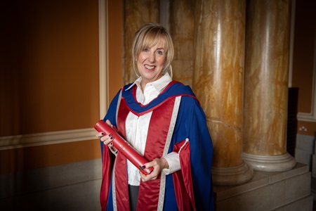 Helena Good holding her honorary degree