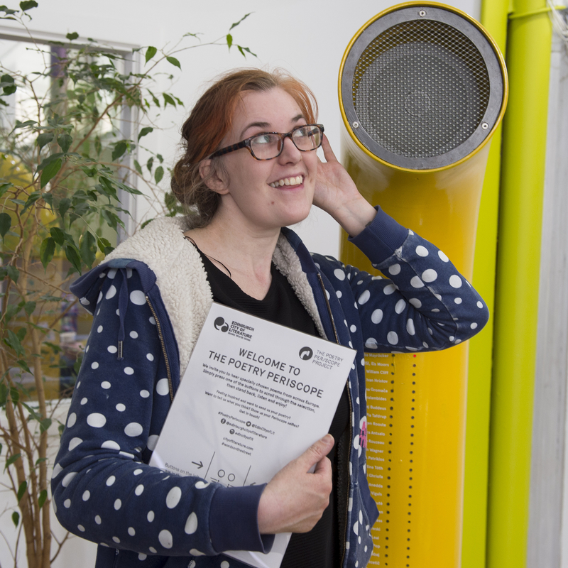 Student holding a piece of paper.