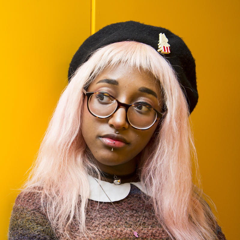 Student portrait on yellow background.