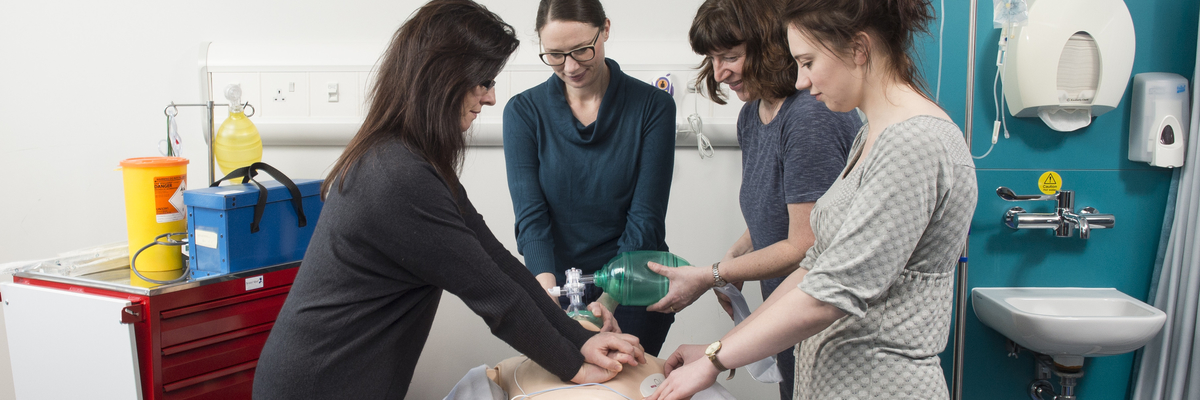 Students practising on a dummy.