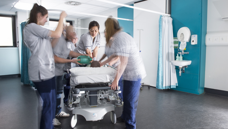 Nursing students practising on a dummy.