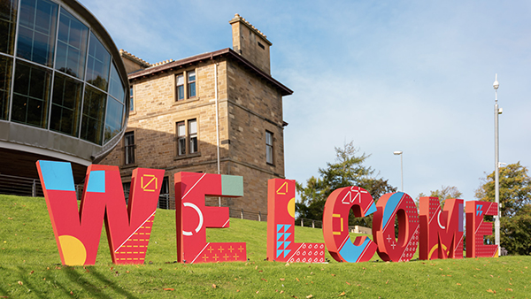 ENU branded big colourful Welcome letters outside on the grass at Craiglockhart campus
