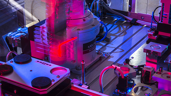 futuristically lit robot arm and wires