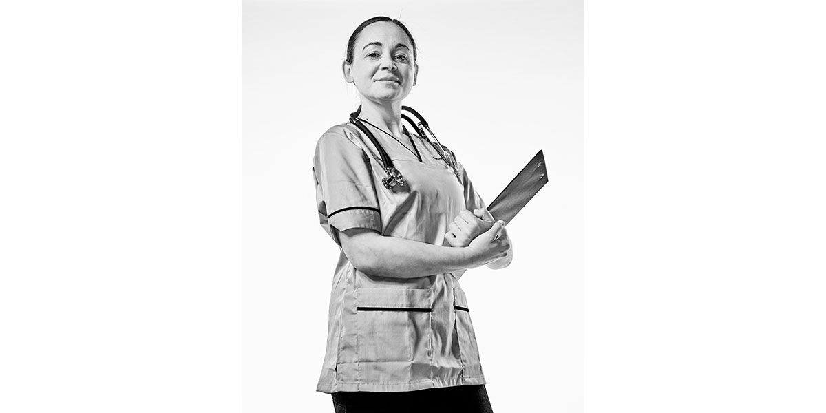 sarah, a child health nursing student at edinburgh napier university, stands confidently in nurse uniform