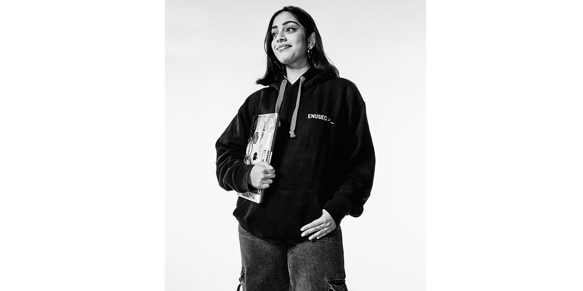 joyee, cybersecurity student at edinburgh napier university, stands with her laptop confidently