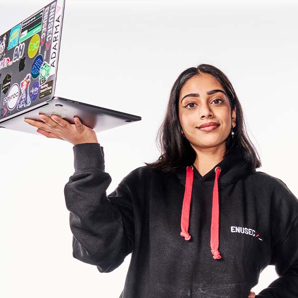 joyee, a cybersecurity student and president of ENUSEC, holds her laptop