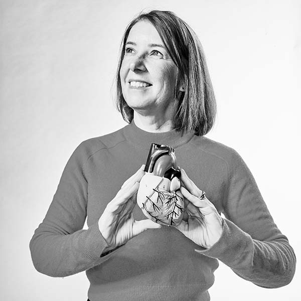 lis neubeck, professor of cardiovascular health and academic at Edinburgh Napier University, smiles and holds 3d model of heart