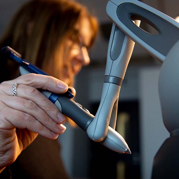 Professor Lis Neubeck (seated) from the School of Health and Social Care and Reseacher Joanna Aldhous from the School of Computing Engineering and the Built Environment working on the Haptic Glove study for the Centre for Cardiovascular Health.