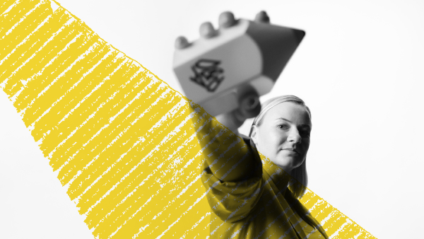 Creative advertising graduate Janina holding D&AD award next to spotlight graphic