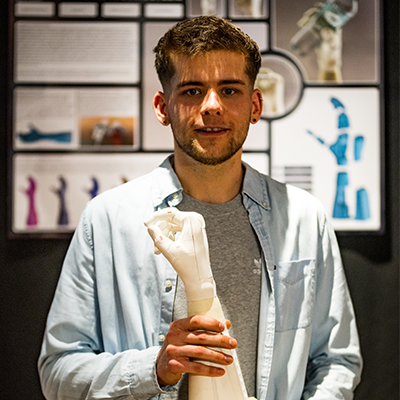 Student Stefan holding prototype of bionic hand