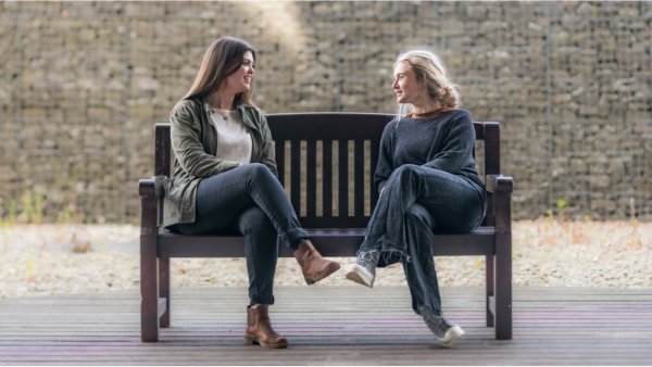 two students sitting on bench at craiglockhart campus